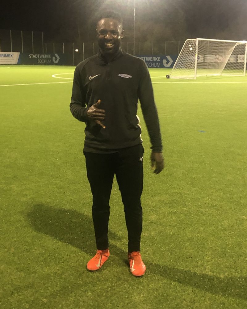 David on a floodlit pitch in Bochum, Germany, in training gear